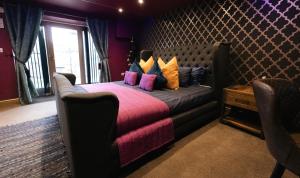 a bedroom with a large bed with colorful pillows at St Hildas Complex in Hinderwell