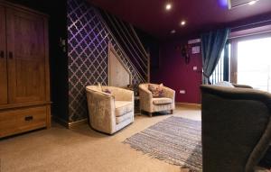 a living room with two chairs and a rug at St Hildas Complex in Hinderwell