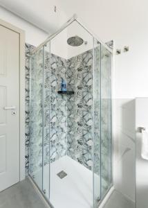 a shower in a bathroom with a glass wall at Rinascimento Apartments in Florence +23 photos