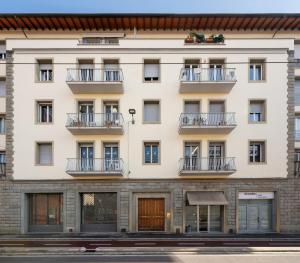 an apartment building with balconies on a street at Rinascimento Apartments in Florence