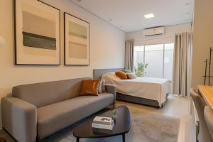 a living room with a couch and a bed at Pousada na praia Peruibe - Vila Thaynara in Peruíbe +112 photos