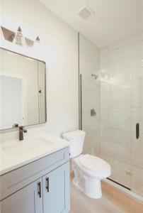 a white bathroom with a toilet and a shower at Brand new home near beautiful beaches in Port Charlotte