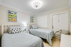 a bedroom with two beds and a window at Naples Condo with Pool - Walk to Dining and Beach in Naples