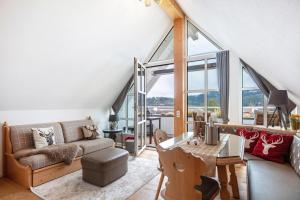 a living room with a couch and a table at Villa Sunside Appartements in Schluchsee