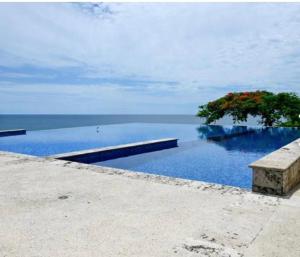 a swimming pool with a tree in the water at Duplex de lujo in Same +6 photos
