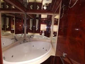 a large bath tub in a bathroom with mirrors at Beautiful Motor Yacht Barcelona in Barcelona