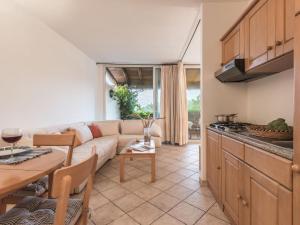 a living room with a couch and a table at Capo Ceraso Family Resort in Costa Corallina