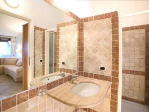 a bathroom with a sink and a bath tub at Capo Ceraso Family Resort in Costa Corallina +19 photos