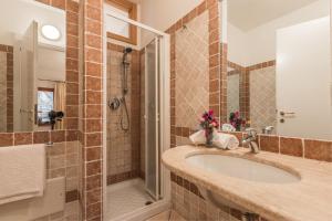 a bathroom with a sink and a shower at Capo Ceraso Family Resort in Costa Corallina