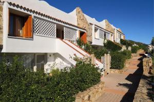 a row of houses on a hill at Capo Ceraso Family Resort in Costa Corallina