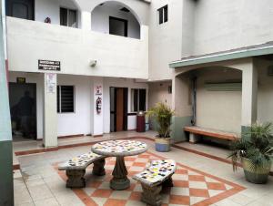 a patio with a table and two benches in a building at hotel economico in Tijuana +4 photos