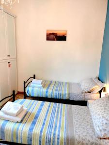 A bed or beds in a room at CASA MAFALDA - Rooms, friends and more - Affittacamere, Guest House