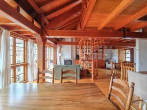 a dining room with a large wooden table and chairs at La Casita del Montañes in Liérganes