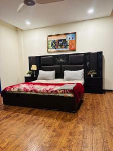 a bedroom with a large bed in a room at Deluxe suite in bahria heights 1 rawalpindi in Rawalpindi