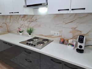a kitchen counter with a stove top in a kitchen at MyApartment in Chişinău
