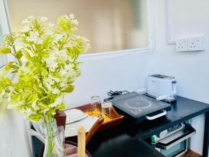 a table with a vase with flowers on it at EIT Masky Villa in Ambalangoda