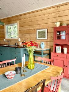 a kitchen with a table with a vase of flowers at Mountain Holiday Homes - Ottsjö, Trillevallen -Sweden in Åre