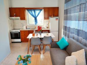 a kitchen with a table and a couch in a kitchen at Nature House Vlatos in Vlátos