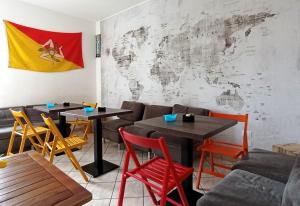a restaurant with two tables and chairs and a flag at Sweet Home Pioppo in Pioppo
