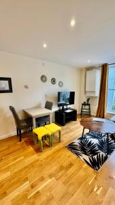 a living room with a table and a dining room at St Leonards Boutique Apartment in Hollington