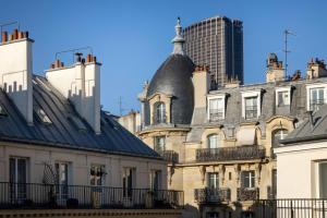 a group of buildings with a skyscraper in the background at Hôtel l'Inattendu in Paris +36 photos