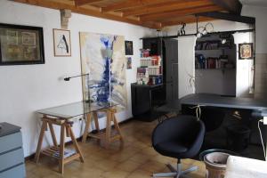 een kamer met een bureau en een tafel en stoelen bij Il Balcone Holiday House in Parma