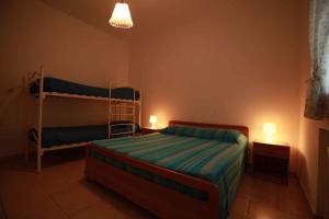 a bedroom with a bed and a bunk bed at Apartment in Rosolina Mare 3 in Rosolina Mare