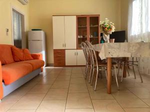 a living room with a couch and a table with chairs at Apartment in Rosolina Mare 3 in Rosolina Mare
