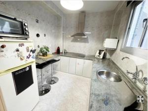 a kitchen with a sink and a refrigerator at La Casita de Ronda in Ronda