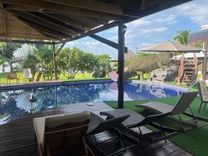 a patio with chairs and a swimming pool at Bahía Caimán , Río dulce in Río Dulce