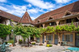 an exterior view of a house with a roof at Hôtel De La Beursaudiere in Nitry +96 photos