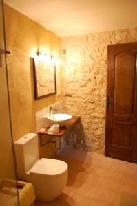 a bathroom with a toilet and a sink at Ca l'Estruch in Vallclara