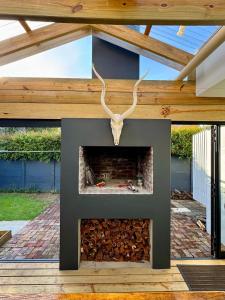 a fireplace with a skull on top of it at Modern Cosy Apartment in Plettenberg Bay