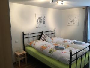 a bedroom with a bed with a black frame at Ferienapartment: An Der Kunstakademie Heimbach in Heimbach