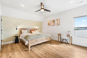 a bedroom with a bed and a ceiling fan at Over the Top in Hollister +86 photos