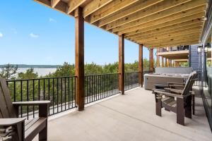 a patio with a grill and chairs on a deck at Over the Top in Hollister
