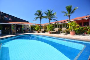 a swimming pool in front of a hotel at Hotel Pousada do Buriti in Barreirinhas