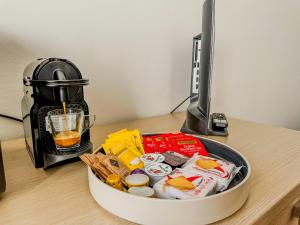 a container of food on a desk next to a coffee maker at Smart Studio - Lingotto, Fiera & Metro in Turin