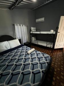 a bedroom with two bunk beds in a room at Rancho Agua Fria casa in Usulután +23 photos