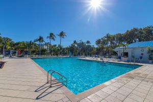 a swimming pool with a bench in a resort at Ocean Pointe Resorts - Serenity 2308 in Tavernier