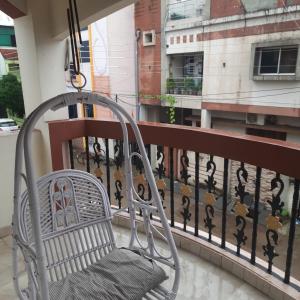 a swinging chair on a balcony with a view at Beautiful AC Room, Best Location, Furnished with Kitchen, TV, Fridge, Washing Machine etc at Pachpedinaka Raipur in Raipur