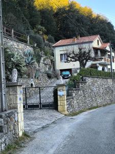 a stone wall next to a house with a driveway at L'Ardéchois in Vals-les-Bains +12 photos