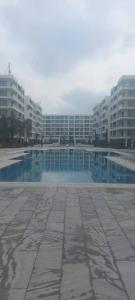 a large swimming pool in a city with tall buildings at Sea Breeze,Park Residents 2 by Tatyana in Baku