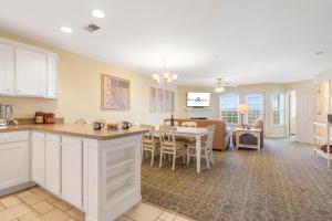 a kitchen and living room with a table and a dining room at Lake Access-Spacious Condo-Free Attraction Tickets-Deck Area in Kimberling City