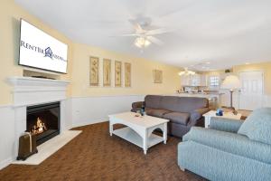 a living room with a couch and a fireplace at Lake Access Condo-Free Daily Tickets-Peaceful Views-Expansive in Kimberling City