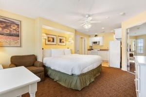 a bedroom with a large bed and a kitchen at Lake Access Condo-Free Daily Tickets-Peaceful Views-Expansive in Kimberling City +53 photos