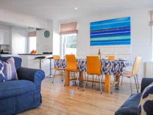 a living room with a dining room table and chairs at Yardarm in Salcombe
