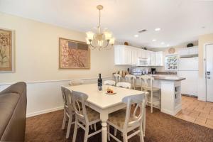 a kitchen and dining room with a white table and chairs at Ozark Vista 129 in Kimberling City