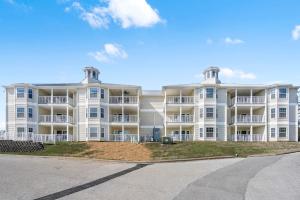 a large white apartment building with a street in front at Ozark Vista 129 in Kimberling City