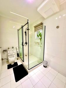 a bathroom with a shower and a toilet at Salpa Homes in Aso
